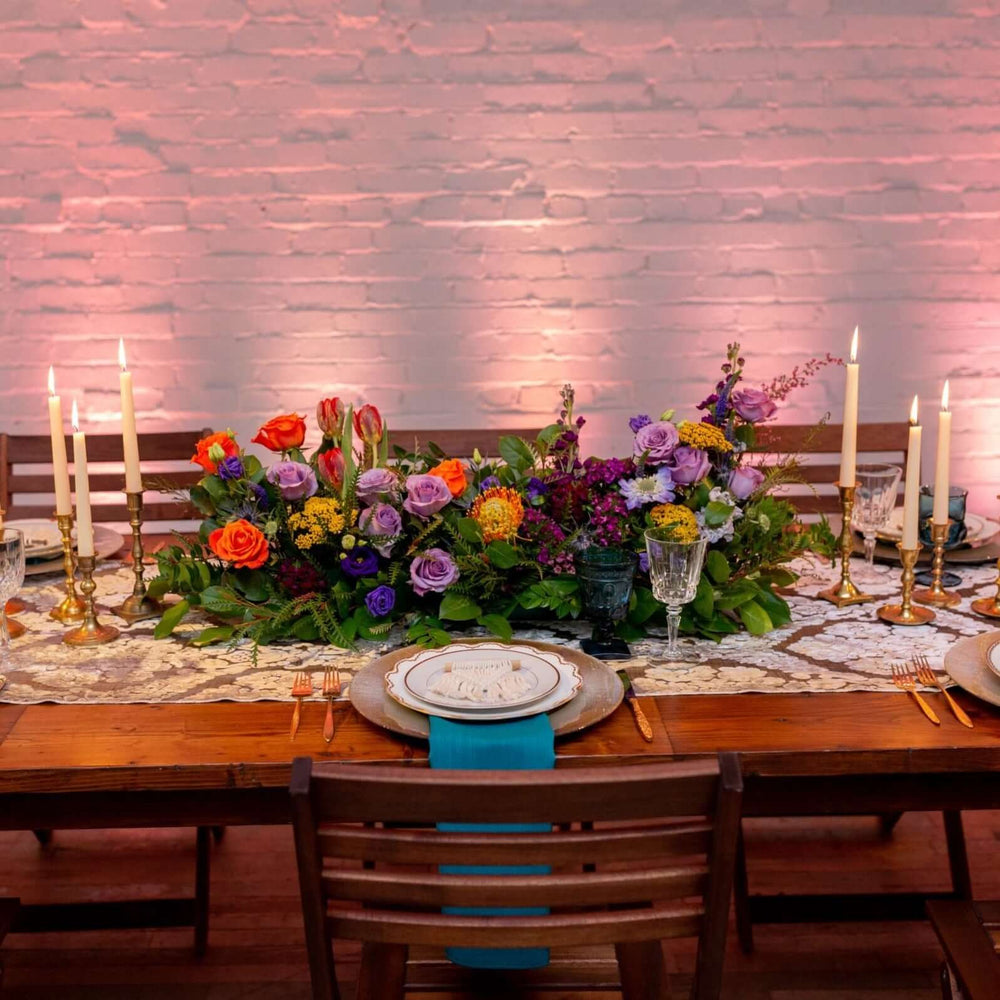 
            
                Load image into Gallery viewer, Colorful long low centerpiece on wood table with white brick wall background
            
        